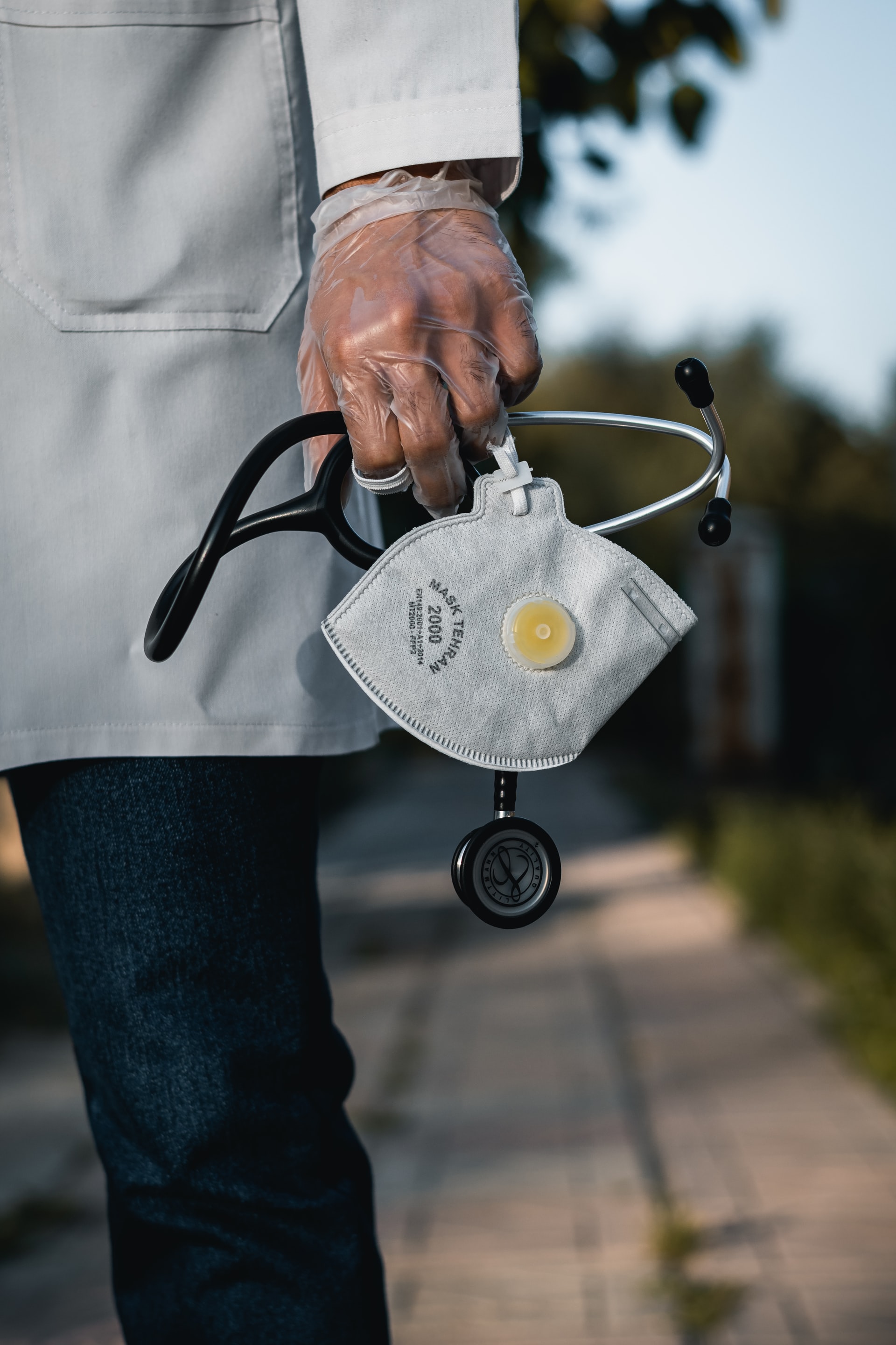 Photo of a doctor holding a stethoscope and mask by ashkan forouzani