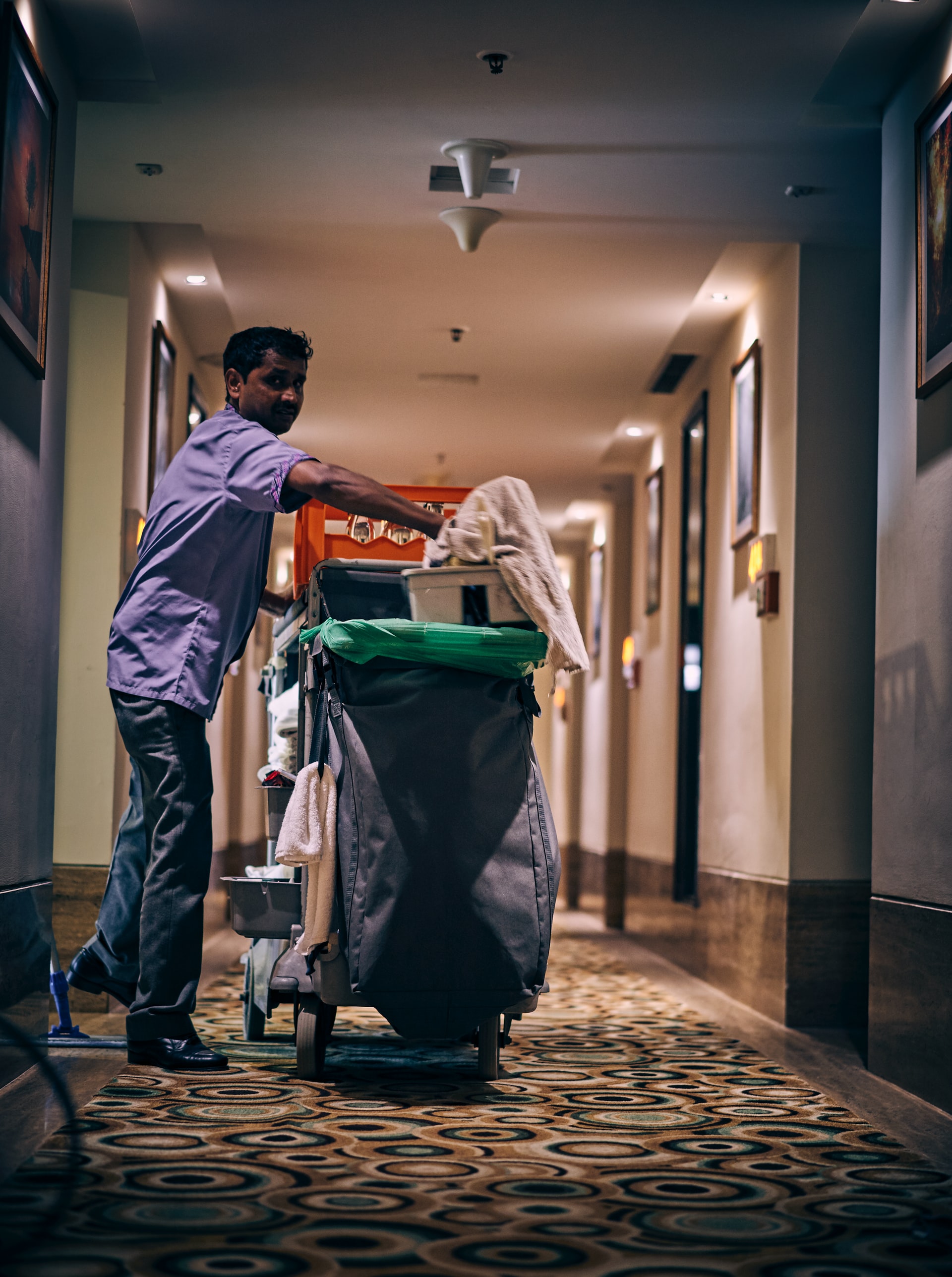 photo of a cleaning service man in a hotel hallway by ashwini chaudhary