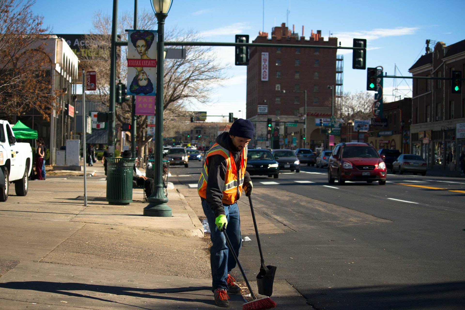 photo of a man cleaning a street sidewalk by denisse leon