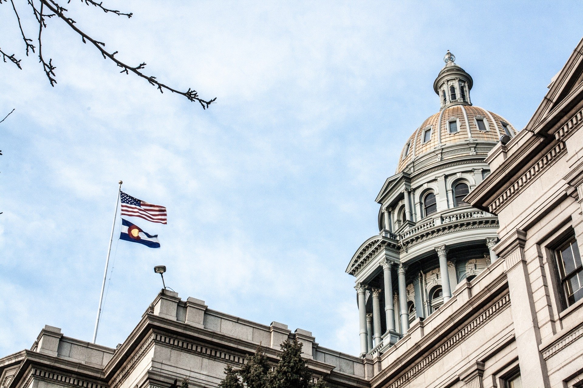 the colorado state capitol and US and Colorado flags