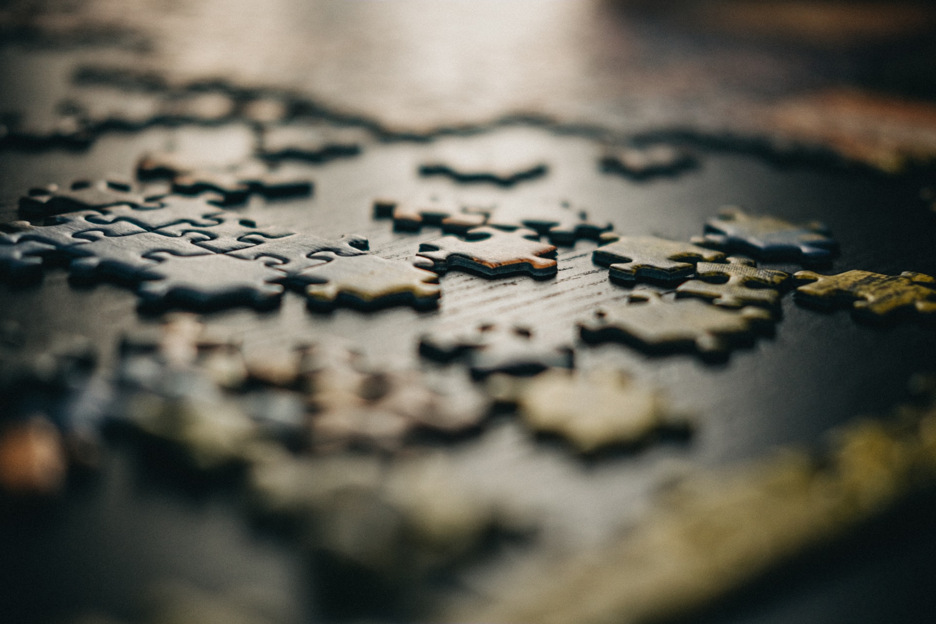 Photo of puzzle pieces on a table by gabriel crismariu

