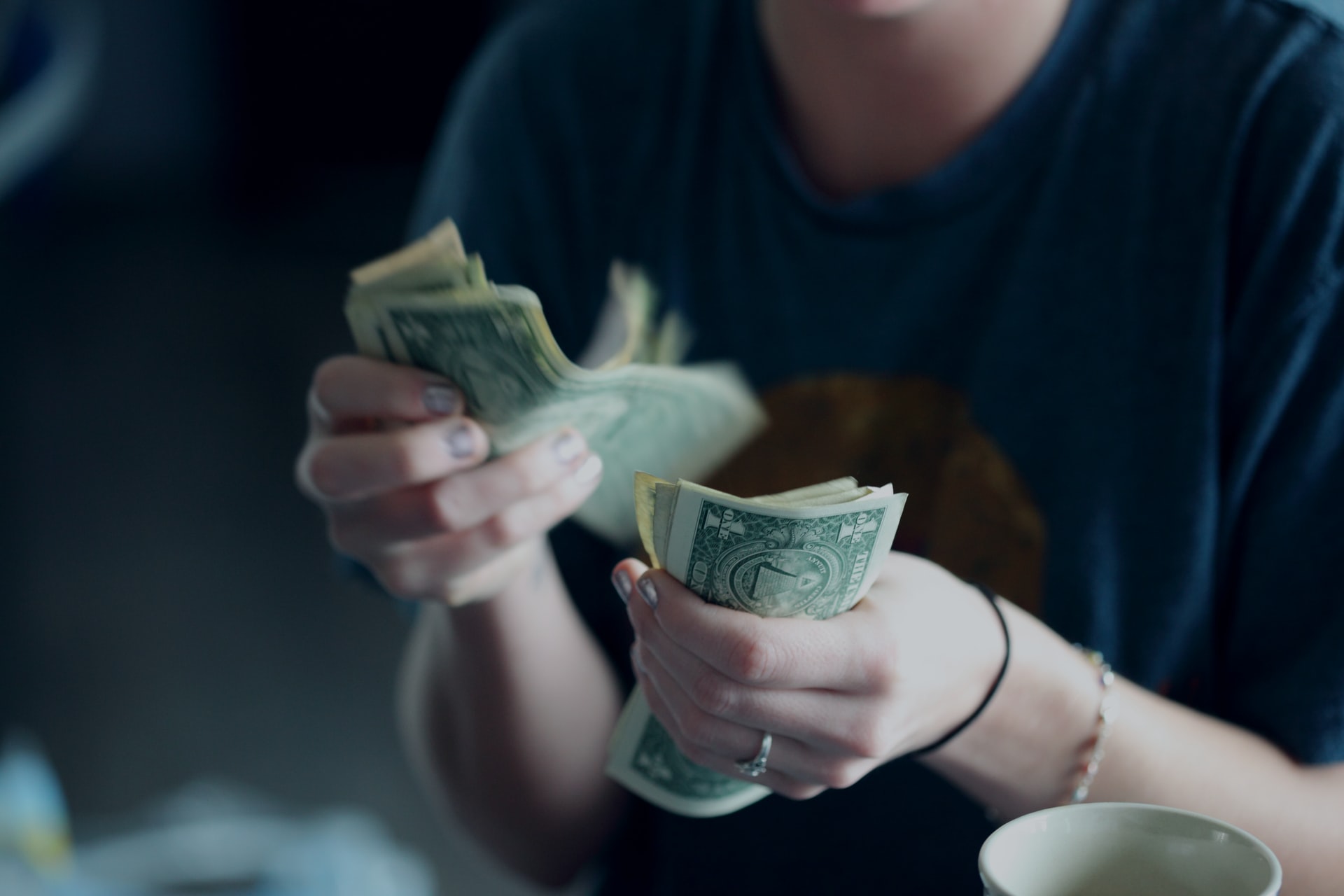 photo of woman counting money by sharon mccutcheon