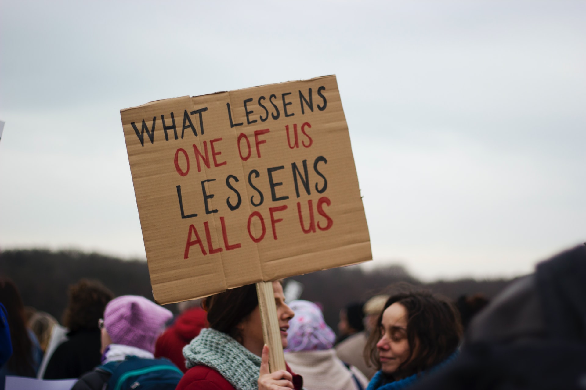 Picture of protester with sign by Micheile Henderson on Unsplash